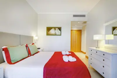 a hotel room with two beds and a television at The Prestige @ The Vilamoura Residences in Quarteira