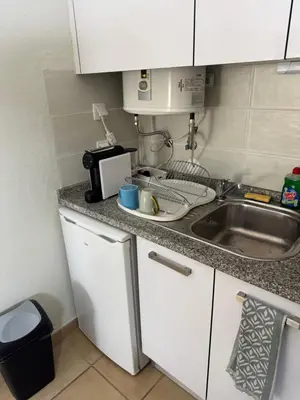 a small kitchen with a sink and a microwave at Relaxing studio in Albufeira Jardim in Albufeira