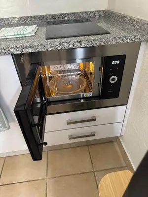 a microwave oven sitting on top of a counter at Relaxing studio in Albufeira Jardim in Albufeira