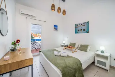 a bedroom with a bed and a desk and a window at Sunlit Balcony & Open Space Flat by HostWise in Albufeira
