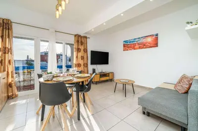 a living room with a table and a couch at Sunlit Balcony & Open Space Flat by HostWise in Albufeira