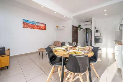 a dining room and kitchen with a table and chairs at Sunlit Balcony & Open Space Flat by HostWise in Albufeira