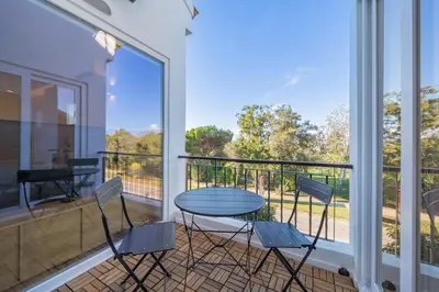 a balcony with a table and chairs and a view at Marina Búzios Vilamoura Central 2-Bedroom Apartments in Vilamoura