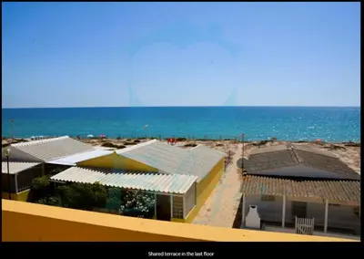 a view of a beach with buildings and the ocean at Blife Mariangya private rooms at Faro beach in Faro