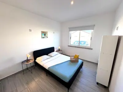 a bedroom with a bed and a window in it at Blife Sonya private rooms at Faro beach in Faro