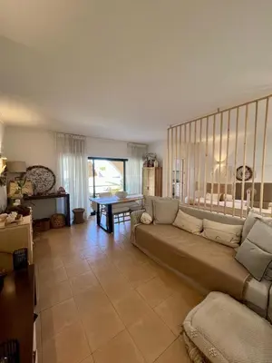 a living room with a couch and a table at Salgados Studio in Guia