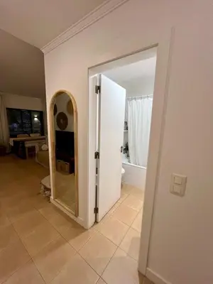 a bathroom with a door and a mirror in a room at Salgados Studio in Guia
