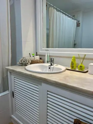 a bathroom counter with a sink and a mirror at Salgados Studio in Guia