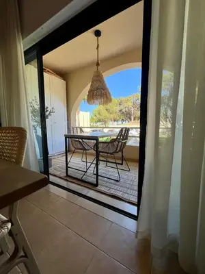 a dining room with a table and chairs on a patio at Salgados Studio in Guia