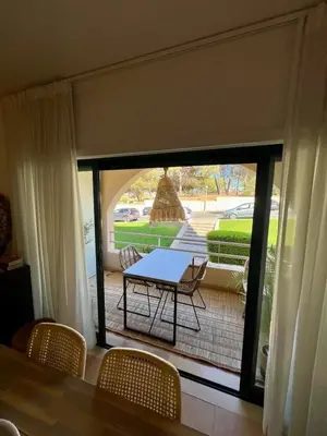 a dining room with a table and chairs and a patio at Salgados Studio in Guia