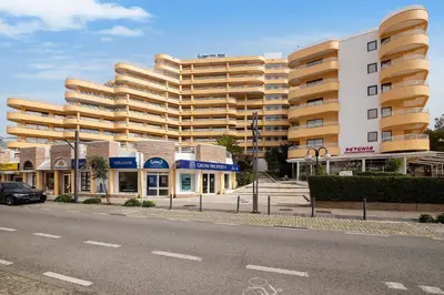 a large apartment building on a city street at Marina Mar in Vilamoura