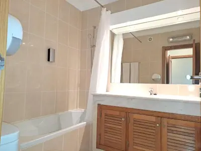 a bathroom with a sink and a tub and a mirror at Superior Two Bedroom Apartment in Clube Albufeira in Albufeira