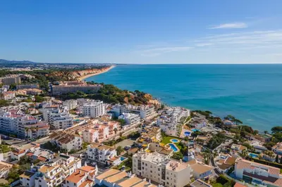 an aerial view of a city and the ocean at Bright 2BR with Pool near Beach by LovelyStay in Albufeira