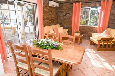 a dining room with a table and chairs at Villa Simões by Delilah Collection in Albufeira