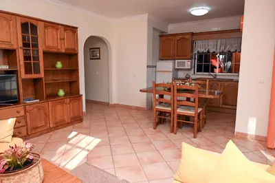 a kitchen with a table and a dining room at Villa Simões by Delilah Collection in Albufeira