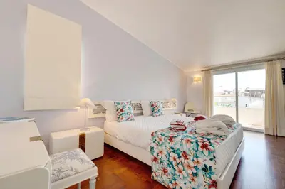 a white bedroom with a bed and a window at Sunrise Beach Villa by Delilah Collection in Albufeira
