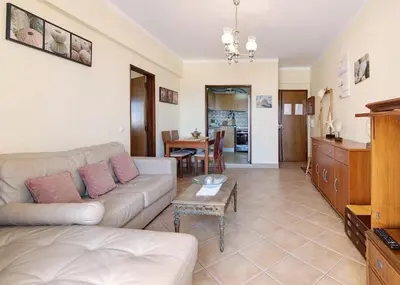 a living room with a couch and a table at VIP T2 Beachfront with Garage in Quarteira