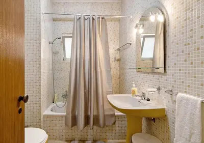 a bathroom with a sink and a shower curtain at VIP T2 Beachfront with Garage in Quarteira