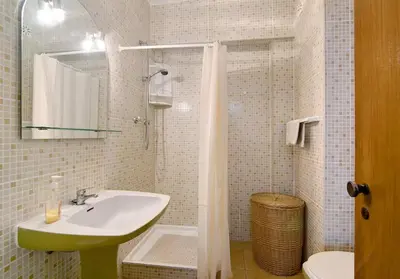 a bathroom with a sink and a mirror and a toilet at VIP T2 Beachfront with Garage in Quarteira
