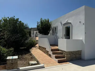 a white house with stairs leading to a yard at Quinta do Olival - Casa Faro Oeste - Calm & wellness in São Brás de Alportel
