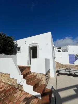 a white house with stairs on a roof at Quinta do Olival - Casa Faro Oeste - Calm & wellness in São Brás de Alportel