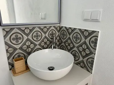 a bathroom with a white sink and a mirror at Quinta do Olival - Casa Faro Oeste - Calm & wellness in São Brás de Alportel
