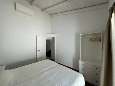 a bedroom with a white bed and a dresser at Quinta Do Olival - Casa Figueira - Calm & wellness in São Brás de Alportel