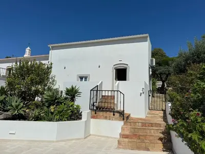 a white house with stairs in front of it at Quinta do Olival - Casa Limão - Calm & wellness in São Brás de Alportel