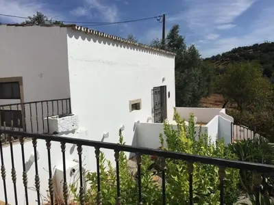 a white house with a gate and a fence at Quinta do Olival - Casa Limão - Calm & wellness in São Brás de Alportel