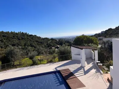 a villa with a swimming pool on top of a house at Quinta do Olival - Casa Limão - Calm & wellness in São Brás de Alportel