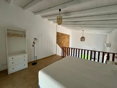 a bedroom with a bed and a dresser in it at Quinta do Olival - Casa Limão - Calm & wellness in São Brás de Alportel