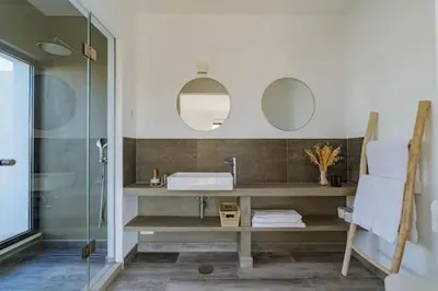 a bathroom with a sink and two mirrors at Amazing Views Villa in Loulé