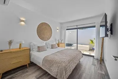 a bedroom with a bed and a large window at Amazing Views Villa in Loulé