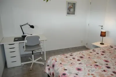 a bedroom with a desk and a bed and a desk and chair at Villa Monte Alegrete with sea view in Faro