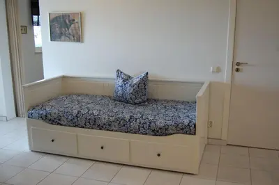 a bed with a pillow on it in a room at Villa Monte Alegrete with sea view in Faro