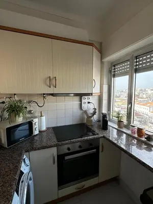 a living room with a flat screen tv on a entertainment center at Old town and Rias view in Faro