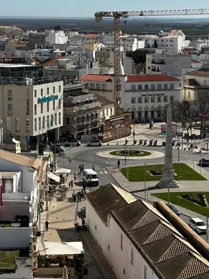 a kitchen with a counter top with a microwave and a window at Old town and Rias view in Faro