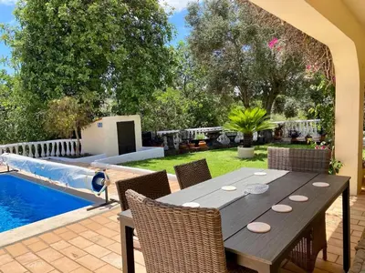 a patio with a table and chairs next to a pool at Casa Mariano Private Heated Pool With Views and AC