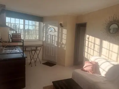 a living room with a couch and a table and a door at Casa Olivier in Loulé