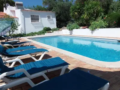 a swimming pool with lounge chairs and a swimming pool at Casa Olivier in Loulé