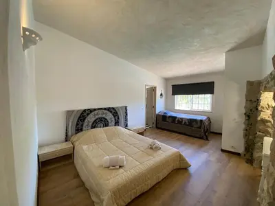 a bedroom with a large bed and a window at Casa Olivier in Loulé