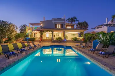 a house with a swimming pool in front of a house at Casa da Praia in Galé