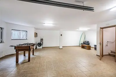 an empty room with a ping pong table in it at Villa Gale Coast in Guia