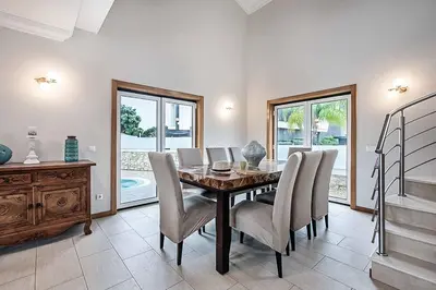 a dining room with a table and chairs at Villa Gale Coast in Guia