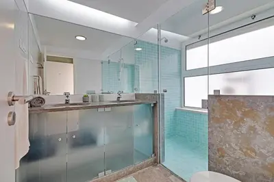 a bathroom with a glass shower and a sink at Terras Novas Albufeira in Albufeira