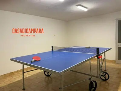 a ping pong table in a room with a tennis court at Casa di Campara Almada Villa in FAO