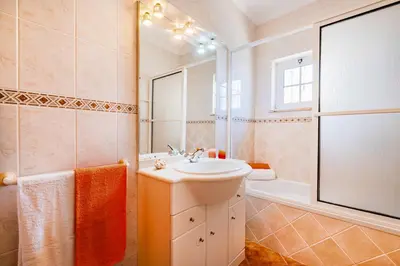 a white bathroom with a sink and a tub at Villa Atlantis by Algarve Vacation in Guia
