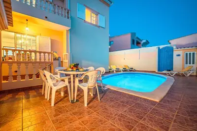 a villa with a swimming pool in front of a house at Villa Atlantis by Algarve Vacation in Guia