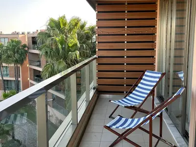 a pair of chairs sitting on a balcony at Vila das Lagoas 9A 3D in Guia