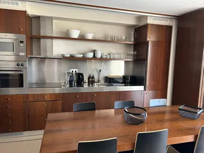 a kitchen with a wooden table with chairs and a counter at Vila das Lagoas 9A 3D in Guia